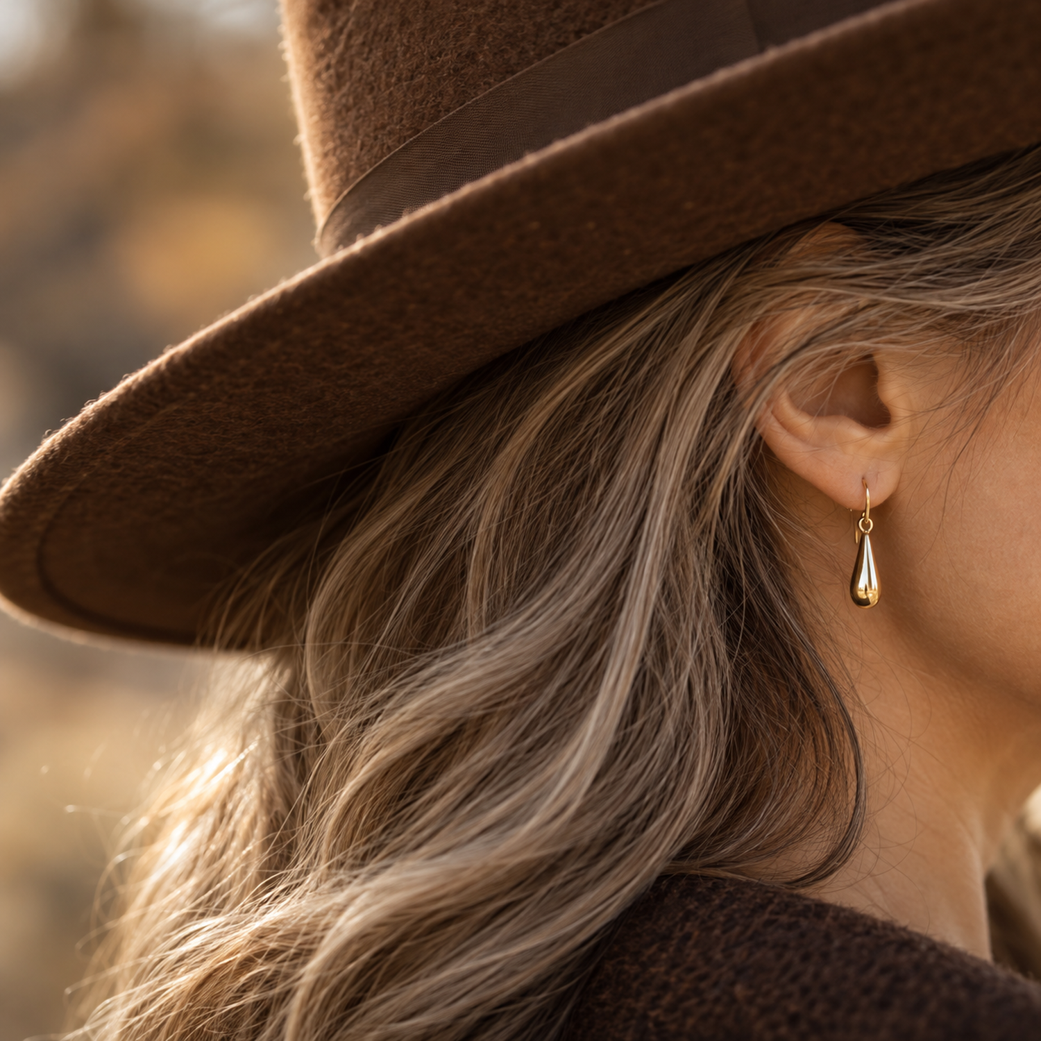 Coffee felt hat brim with a simple drop earring, styling illustration